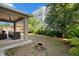 Features a covered patio, comfortable seating, a fire pit, and landscaped greenery at 1520 W Fig St, Tampa, FL 33606