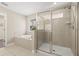 Bathroom with a glass-enclosed shower, soaking tub, and tiled walls at 1520 W Fig St, Tampa, FL 33606
