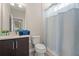 Bathroom with a sleek vanity, toilet, and shower featuring a white curtain at 1520 W Fig St, Tampa, FL 33606