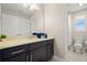 Bathroom with a large mirror over the vanity and an adjacent toilet at 1520 W Fig St, Tampa, FL 33606