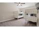 Bedroom featuring white bunk beds, a ceiling fan, and carpet floors at 1520 W Fig St, Tampa, FL 33606