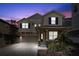 Inviting two-story home featuring a cozy front porch and well-manicured landscaping at twilight at 1520 W Fig St, Tampa, FL 33606