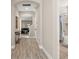 Bright hallway with wood floors, with a bathroom to the right and living area straight ahead at 1520 W Fig St, Tampa, FL 33606