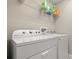 Laundry room featuring a Whirlpool washer and dryer, with storage space at 1520 W Fig St, Tampa, FL 33606