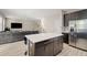 Open-concept living room and kitchen area featuring stainless steel appliances and tile flooring at 1520 W Fig St, Tampa, FL 33606