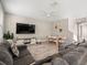 Spacious living room and dining area with a ceiling fan, grey sofa, and table with chairs at 1520 W Fig St, Tampa, FL 33606