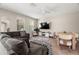 Bright living room showcasing a grey sofa, wooden table and chairs, and large windows at 1520 W Fig St, Tampa, FL 33606