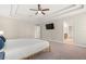 Spacious main bedroom showcasing a tray ceiling, carpet floors, and ensuite bathroom at 1520 W Fig St, Tampa, FL 33606