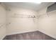 Walk-in closet with multiple shelving units, carpet flooring, and ample space for storage at 1520 W Fig St, Tampa, FL 33606