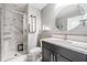 Bathroom featuring a glass-enclosed shower, neutral tones, and updated fixtures at 1543 W Cass St, Tampa, FL 33606