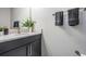 Clean bathroom featuring a dark vanity, quartz countertop, and neutral tones at 1543 W Cass St, Tampa, FL 33606