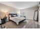Cozy bedroom featuring a comfortable bed, stylish decor, and hardwood floors at 1543 W Cass St, Tampa, FL 33606