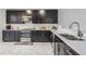 Modern kitchen featuring stainless steel appliances, subway tile backsplash, and marble countertops at 1543 W Cass St, Tampa, FL 33606