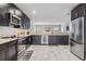 Open-concept kitchen featuring stainless steel appliances, sleek countertops, and ample storage at 1543 W Cass St, Tampa, FL 33606