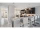 Modern kitchen with sleek dark cabinetry, bar seating, and stainless steel appliances at 1543 W Cass St, Tampa, FL 33606