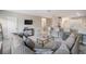 Open-concept living room with a large gray couch, bar seating, and kitchen access at 1543 W Cass St, Tampa, FL 33606