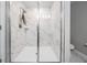 Elegant shower with glass doors and white marble tiling at 1543 W Cass St, Tampa, FL 33606