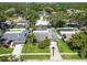 Aerial view of a home featuring a well-kept lawn, beautiful trees and driveway at 1622 El Tair Trl, Clearwater, FL 33765