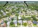 Located near Clearwater Beach, aerial view features a home with a pool and screened enclosure at 1622 El Tair Trl, Clearwater, FL 33765