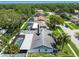 Aerial view of a well-maintained home with a screened pool enclosure and a lush, green backyard at 1622 El Tair Trl, Clearwater, FL 33765
