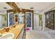 Bathroom with leafy wallpaper featuring an oversized vanity, dual sinks, and mirror at 1622 El Tair Trl, Clearwater, FL 33765