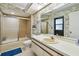 Bathroom with shower, toilet, sink, and a large mirror at 1622 El Tair Trl, Clearwater, FL 33765