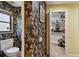 Bathroom with leafy wallpaper leading to a walk-in closet at 1622 El Tair Trl, Clearwater, FL 33765