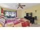 Bedroom features large bed, ceiling fan, and patio view at 1622 El Tair Trl, Clearwater, FL 33765
