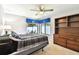 Bright bedroom features ceiling fan, dresser, and backyard view at 1622 El Tair Trl, Clearwater, FL 33765