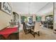 Open dining room with large windows, view to the backyard and mirror wall at 1622 El Tair Trl, Clearwater, FL 33765
