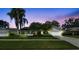 Charming single-story home boasting mature landscaping and a well-manicured lawn at twilight at 1622 El Tair Trl, Clearwater, FL 33765