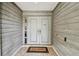 Inviting front entrance featuring double doors, sidelight window, and a welcome mat at 1622 El Tair Trl, Clearwater, FL 33765