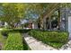 Charming home featuring vibrant landscaping and a concrete walkway leading to the main entrance at 1622 El Tair Trl, Clearwater, FL 33765