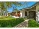 Charming home featuring colorful foliage and a walkway leading to the main entrance at 1622 El Tair Trl, Clearwater, FL 33765