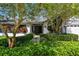 Charming home featuring vibrant landscaping and a walkway leading to the main entrance at 1622 El Tair Trl, Clearwater, FL 33765
