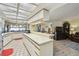 Spacious kitchen with a bright interior, white cabinets, and a breakfast bar overlooking the Gathering room at 1622 El Tair Trl, Clearwater, FL 33765
