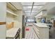 Bright kitchen with stainless steel appliances, white cabinetry, and tile floors at 1622 El Tair Trl, Clearwater, FL 33765