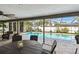 Screened in lanai including outdoor dining table and lounge area and views of the swimming pool at 1622 El Tair Trl, Clearwater, FL 33765