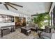 View of the covered lanai featuring a lounge area and sliding door into a bedroom, with a ceiling fan at 1622 El Tair Trl, Clearwater, FL 33765