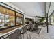 The covered lanai includes an outdoor bar with stools, dining table, lounge area, and views of the pool at 1622 El Tair Trl, Clearwater, FL 33765