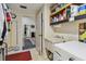 Practical laundry room with built-in shelves and access to rest of home at 1622 El Tair Trl, Clearwater, FL 33765