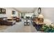 Comfortable living room with leather furniture, a modern coffee table, and a view of the screened lanai at 1622 El Tair Trl, Clearwater, FL 33765