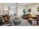 Open concept living room with neutral color palette and carpet, perfect for relaxation and entertaining guests at 1622 El Tair Trl, Clearwater, FL 33765