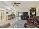 Open concept living room with tile floors, breakfast bar, and an abundance of natural light at 1622 El Tair Trl, Clearwater, FL 33765