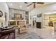 Spacious living room showcasing fireplace with stone accent wall and access to the kitchen at 1622 El Tair Trl, Clearwater, FL 33765