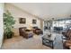 Bright living room with plush chairs, decorative art, and view to outdoor lanai and pool at 1622 El Tair Trl, Clearwater, FL 33765