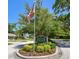 A welcoming 'Coachman Ridge' community sign surrounded by vibrant greenery and landscaping at 1622 El Tair Trl, Clearwater, FL 33765