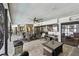 A covered patio with an outdoor kitchen, dining area, lounge, and a view of the pool creates a perfect outdoor space at 1622 El Tair Trl, Clearwater, FL 33765