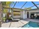 Relax by the pool with an outdoor kitchen, lounge chairs, and covered patio for a fantastic outdoor experience at 1622 El Tair Trl, Clearwater, FL 33765