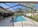 Enjoy the best in outdoor living with the in-ground pool, covered patio, bar seating, and lounge chairs at 1622 El Tair Trl, Clearwater, FL 33765